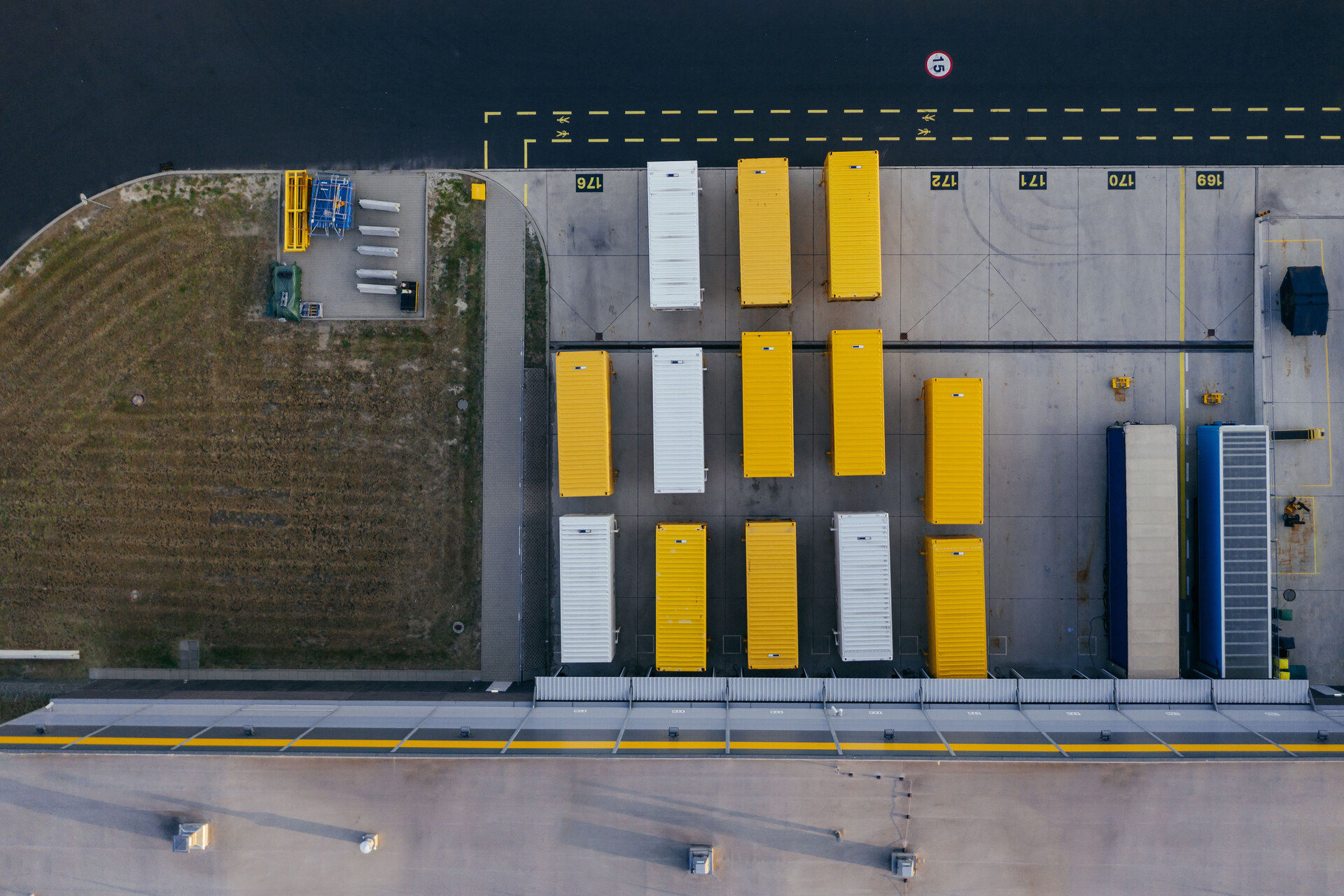 Aerial view of loading bays and trailers at a logistics warehouse